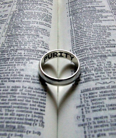 Purity Ring Creating Heart Shadow in Bible.