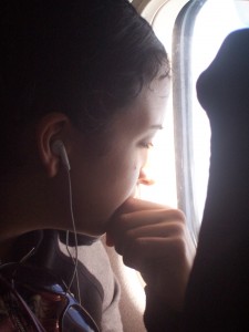 Student on plane with iPod
