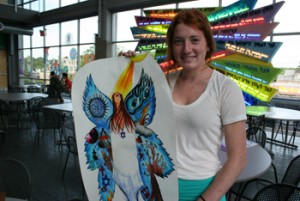 Photo of a student holding her artwork