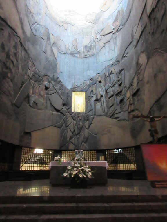 Photo of altar situated in large stone sanctuary
