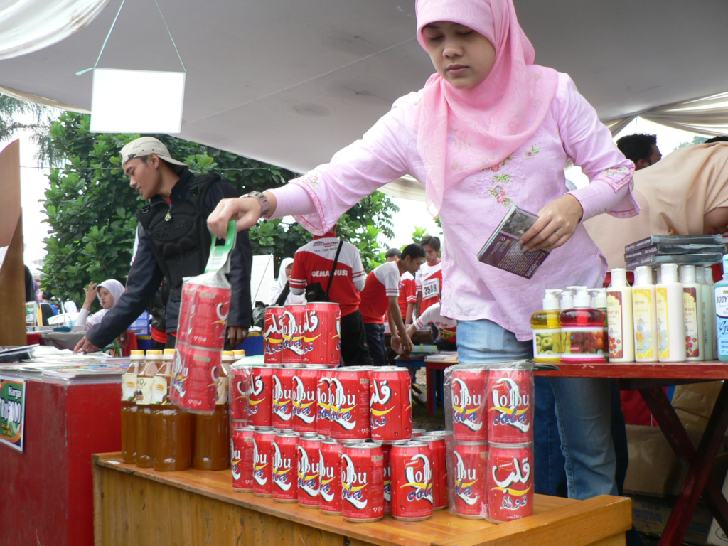 Girl lifting cans of cola